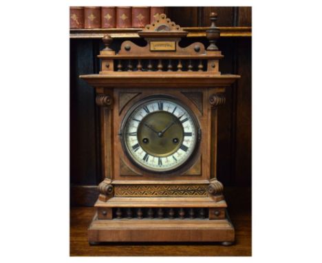 Late 19th Century German walnut and pine cased mantel clock, the brass dial having an off-white chapter ring with Roman numer