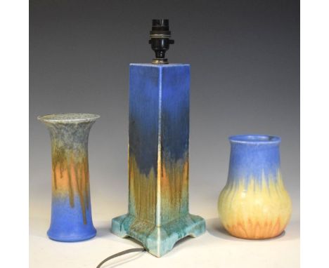 Three items of early 20th Century Ruskin pottery comprising a triangular lamp base, flared cylindrical vase and bulbous vase,