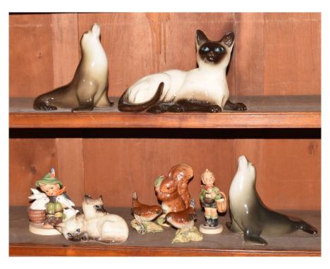 Assorted ceramics to include; M.J.Hummel (Goebel) figures, Royal Doulton reclining Siamese cat model 1559, Beswick kittens mo