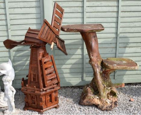 Large stained wooden garden ornament modelled as a windmill, 128cm high, together with a wooden two-tier display stand with t
