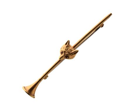 Unmarked gold coloured metal bar brooch in the form of a horn with fox head mount having ruby eyes, 4.9g approx, in a Garrard