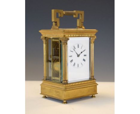 Large French brass cased carriage clock having a repeat movement, white enamel dial with Roman numerals flanked by Corinthian