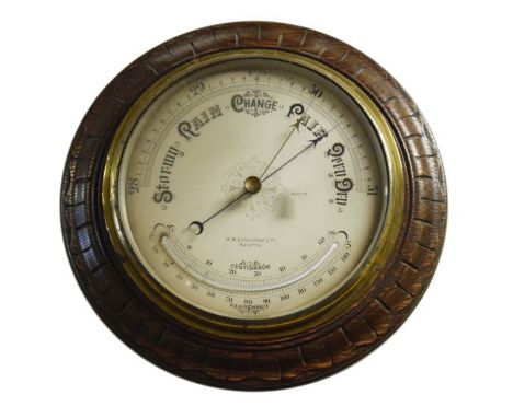 Early 20th Century carved oak framed circular barometer and thermometer, the silvered dial with engraved decoration   Conditi