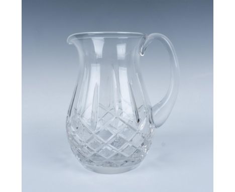 A beautiful clear crystal jug with a smooth curve handle. The vessel is decorated in a crisscross and vertical cut pattern. W