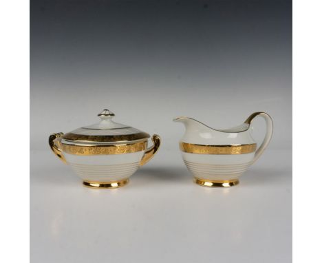White fine china decorated in 22kt gold trims, the edge features an acid-etching clover pattern over the gold band. Set inclu