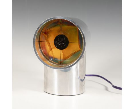 A unique metal clock shaped like a T, featuring a colorful rotating light fixture. Aurora manufacturing tag. Serial Number 39