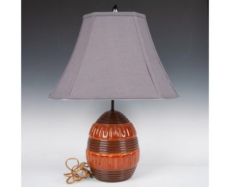 Copper-hued ceramic with geometric raised relief design. Issued: 20th centuryDimensions: 24.5"L x 7.5" dia. Condition: Age re
