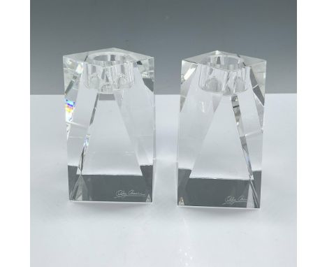 Stunning duo of clear crystal taper candle holders, expertly crafted in a sleek prism shape. These elegant holders capture an