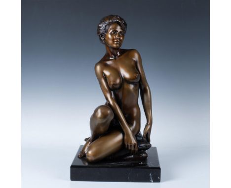 Limited edition. A beautiful bronze statue in a golden-brass tone. Depicts a bare beauty seated on stacks of pillows. The scu