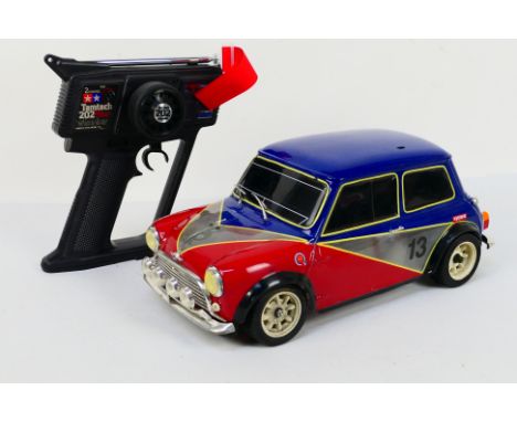 Tamiya - Kyosho - A 1:10 electric RC 'Rover Mini Cooper'. The model shows signs of use appearing to be in Very Good condition