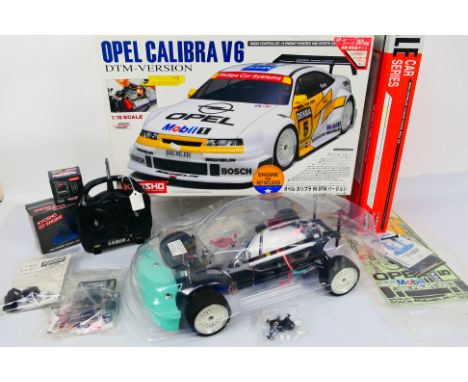 Kyosho - A boxed Kyosho #31404 1:10 scale nitro RC Opel Calibra V6 DTM Version. The model appears partially assembled and com