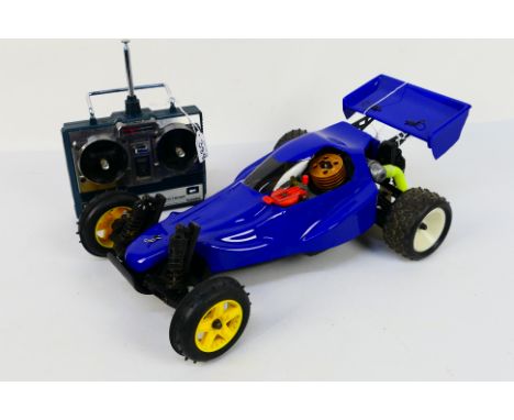 Kyosho - An unboxed Kyosho 1:10 scale nitro RC Sandmaster Buggy. The model shows signs of use with some scratches to undersid