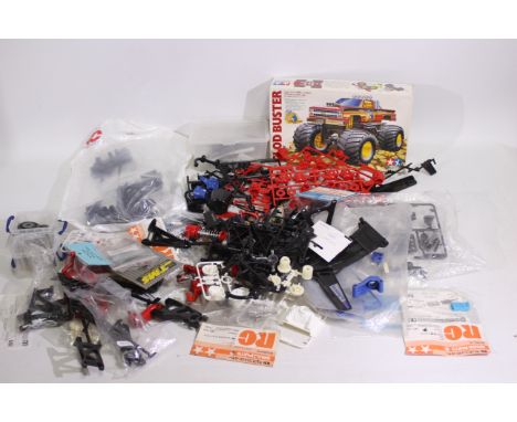 Tamiya - A box containing a large quantity of parts which appear to relate to various Tamiya RC model kits such as Hotshot, C