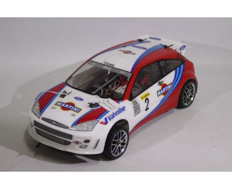 Kyosho - An unboxed Kyosho 1:10 scale nitro RC Ford Focus WRC. The model comes with Kyosho GX-11 nitro engine, and has swing 