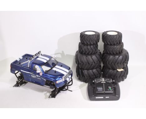 Kyosho - An unboxed Kyosho 1:10 scale nitro RC QRC 'Wild Dodge Ram' Monster Truck. The chassis which is fitted with a GS engi