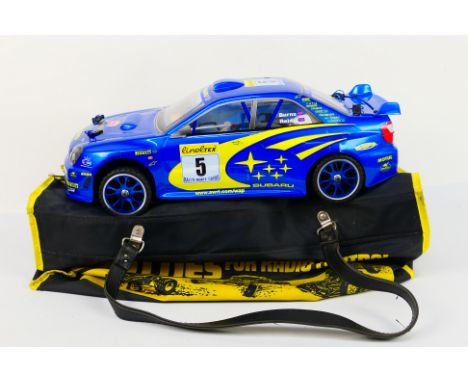 Kyosho - An unboxed Kyosho 1:10 scale nitro Front Wheel Drive RC Mantis GPFF Subaru Impreza. The chassis shows very little si