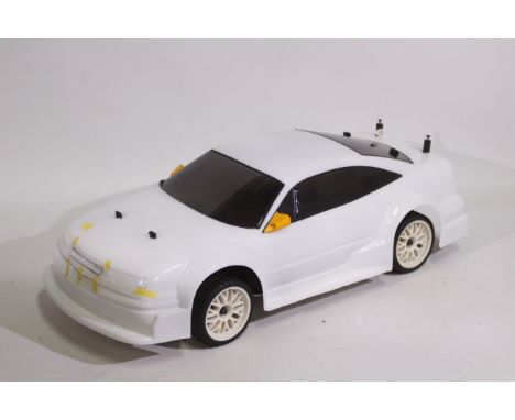 Kyosho - An unboxed Kyosho 1:10 scale nitro RC QRC Opel Calibra V6. The chassis has a swing label attached which suggests the