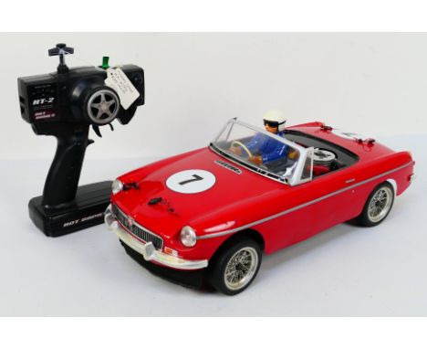 Kyosho - An unboxed Kyosho 1:10 scale nitro RC Spider MGB Mk.1. The model shows some signs of use with some light surface mar