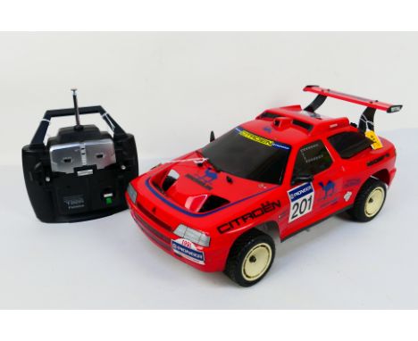 Kyosho - An unboxed Kyosho 1:10 scale nitro RC Citroen ZX Rallye Raid. The chassis shows signs of light use and the body shel