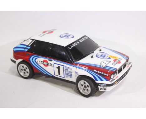 Kyosho - An unboxed Kyosho 1:10 scale nitro RC Lancia Delta Integrale 16V. The model is fitted with Kyosho GS11 engine but ap