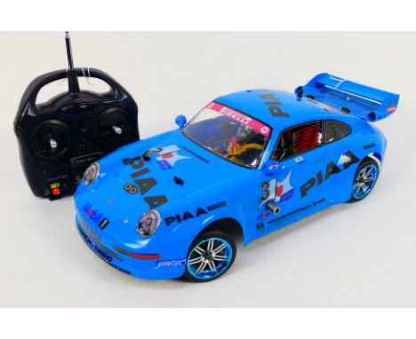 Kyosho - An unboxed Kyosho 1:10 scale nitro RC Spider Special Chassis  with Tamiya Porsche 911 Bodyshell. The model shows ver