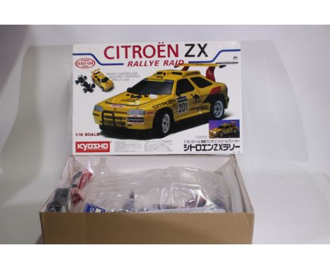 Kyosho - A boxed Kyosho #3163 1:10 scale electric RC Citroen ZX Rallye Raid kit. The model appears partially assembled and co