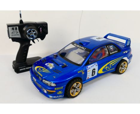 Kyosho - An unboxed Kyosho 1:10 scale electric 4WD RC PureTen EP Alpha Subaru Impreza. The model shows a few signs of use wit