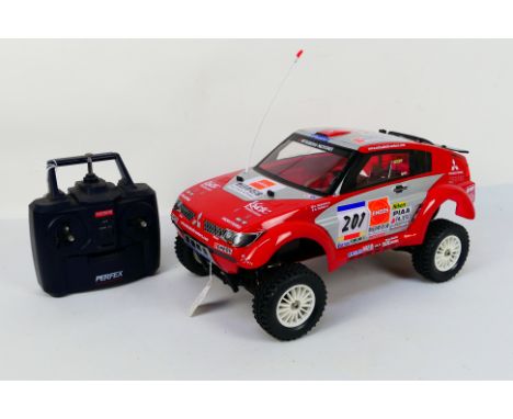 Kyosho - An unboxed Kyosho 1:10 scale nitro RC 4WD QRC Series Mitsubishi Pajero Evolution For The Dakar 2004. The model appea