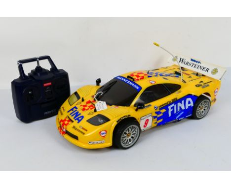 Kyosho - An unboxed Kyosho 1:10 scale nitro RC McLaren BMW F-1 GTR 4WD FW-03. Overall the model exhibits some signs of use wi