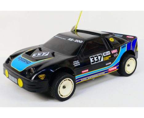 Kyosho - An unboxed Kyosho 1:10 scale nitro RC Ford RS-200. The model shows light signs of use, with some light marks to body