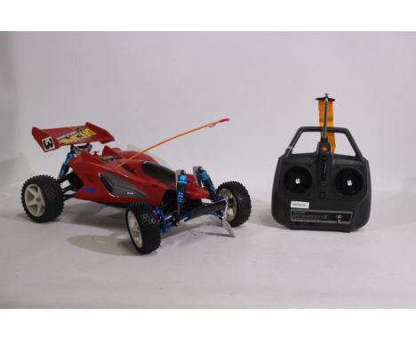 Tamiya - An unboxed Tamiya 1:10 electric RC 'Manta Ray' buggy. The model shows signs of age and use with scratches to undersi