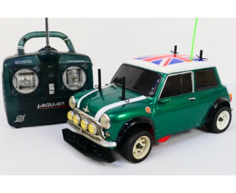 Kyosho - An unboxed Kyosho 1:10 scale nitro RC GP Mantis FF Mini Cooper Mk.1. The model shows signs of use with some scratche