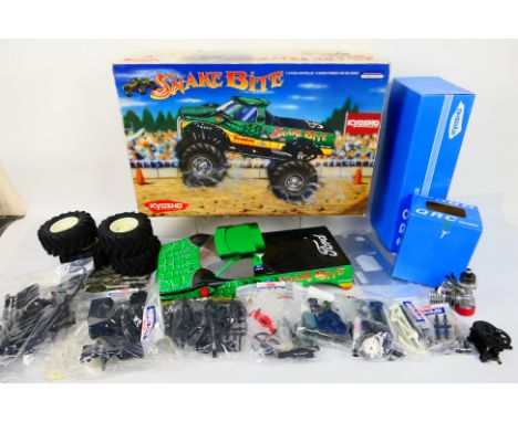 Kyosho - A boxed Kyosho 31991 1:10 scale nitro RC 4 ORC Series 'Snake Bite' Monster Truck kit. The kit comes with painted bod