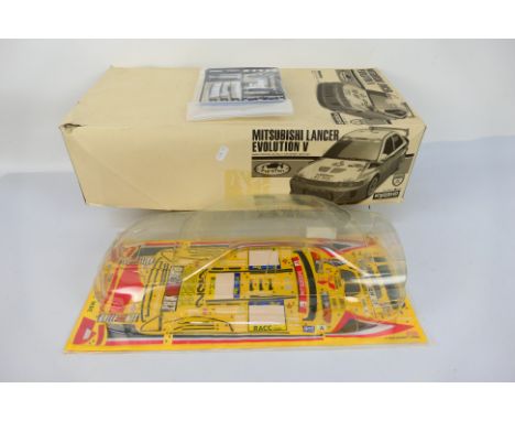 Kyosho - A boxed Kyosho #39822 Mitsubishi Lancer Evolution V nitro RC Rally Car Series Body Set. The body set contains bodysh