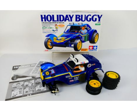 Tamiya - A boxed Tamiya #58470 1:10 scale nitro RC Off Road Car 'Holiday Buggy'. The model is constructed, with wheels detach