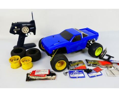 Kyosho - An unboxed Kyosho 1:10 scale nitro RC Buggy chassis with an unmarked custom body shell in style of Ford Pick Up. The