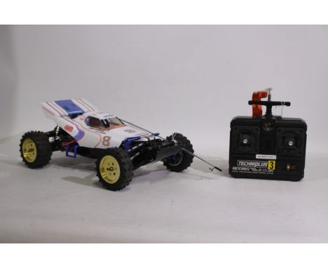 Tamiya - An unboxed Tamiya 1:10 electric RC 'Boomerang' Off Road Racer. The model shows signs of age with some fading to deca