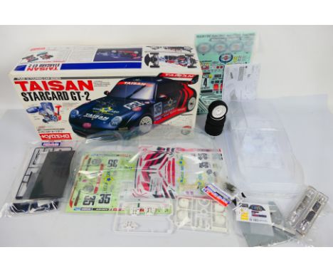 Tamiya - Kyosho - Two 1:10 scale RC body shells. Lot consists of a Tamiya Lancia Delta Integrale - the shell appears Mint and