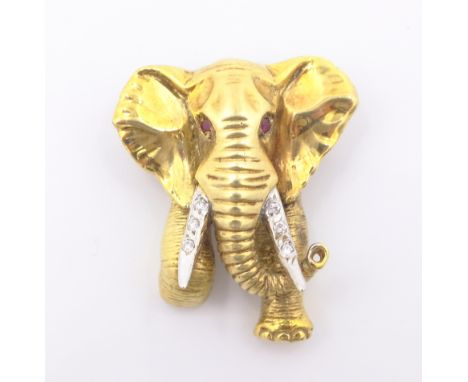 Gold elephant brooch/pendant, diamond set tusks and ruby eyes stamped 14ct Condition Report Approx 10gm length 3cmClick here 