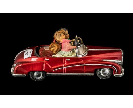 Large Vintage Rolls Royce Type Tinplate Car in red livery, with a loving couple in the driving seat, the girl holding an elec
