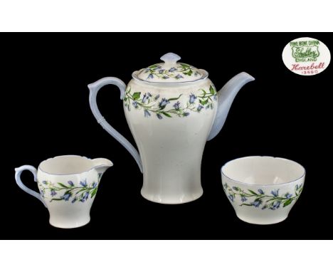 Shelley Bone China 'Karebell' Set comprising teapot, sugar bowl and milk jug, all in white ground with delicate blue flower t