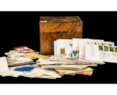An Antique Walnut Hinged Box containing a small quantity of stamps to include First Day Covers, odd loose and mint. To sort.