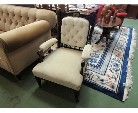 A circa 1890 ebonised armchair with gilt relief having ring turned and reeded decoration the hand painted bird over a button 