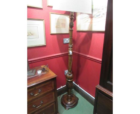 An oak standard lamp with shade the turned column with fluted and carved Tudor Rose decoration on a circular base and flat bu
