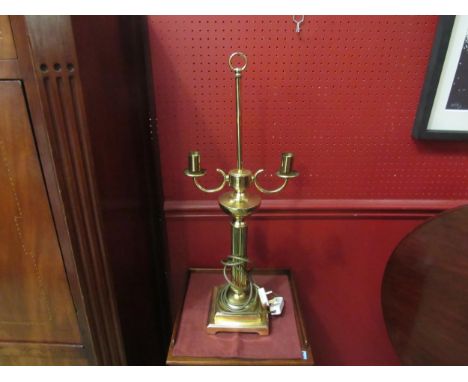 A large brass twin arm table lamp on reeded column to square base 