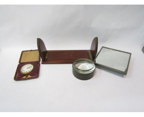 A dressing table mirror, table magnifier, leather travelling clock and a small book slide (4) 