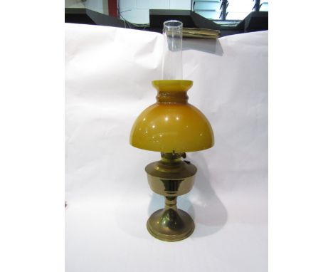 A brass oil lamp with glass shade 