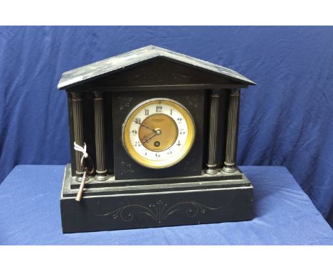 Victorian black slate mantel clock with Corinthian column supports, the gilt and white enamel dial marked Clare & Sons Bedfor