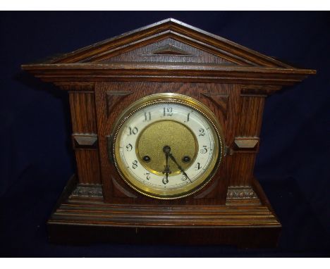 Early 20th C ebony cased striking mantel clock, the brass movement stamped with Junghans