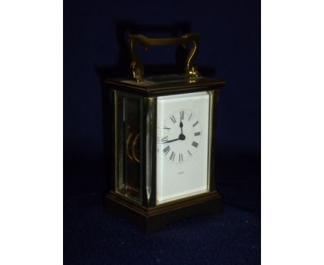 Brass bevelled edge glass paneled cased carriage clock by A Fattorini of Harrogate with swing handle (8cm x 6.5cm x 15cm)